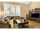 Open living room with hardwood floors, natural light, and built-in entertainment center at 9164 E Lost Hill Trl, Lone Tree, CO 80124