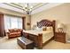 The primary bedroom features a coffered ceiling, chandelier, and a luxurious king-size bed with leather headboard at 9164 E Lost Hill Trl, Lone Tree, CO 80124