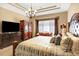 Spacious primary bedroom boasts a TV, large dresser, and comfortable couch for relaxing in a luxurious setting at 9164 E Lost Hill Trl, Lone Tree, CO 80124