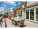 Outdoor dining area with a large table and seating, plus a charming brick fireplace at 9164 E Lost Hill Trl, Lone Tree, CO 80124