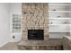 Close up of a striking stone fireplace with an inviting hearth and decorative shelving at 2101 S Victor St # C, Aurora, CO 80014
