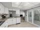 Bright kitchen features stainless steel sink, white cabinetry, and an adjacent living space at 2101 S Victor St # C, Aurora, CO 80014