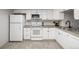 Well-lit kitchen features white appliances, ample cabinetry, and tiled floors at 2101 S Victor St # C, Aurora, CO 80014