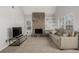 Inviting living room featuring a stone fireplace, vaulted ceiling and built-in shelving at 2101 S Victor St # C, Aurora, CO 80014