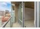 This balcony features city views, glass railings, and an entry into the building at 891 14Th St # 1506, Denver, CO 80202