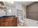 This bathroom features a bathtub, granite countertops, and wood cabinets at 891 14Th St # 1506, Denver, CO 80202