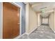 This building hallway features geometric carpet, recessed lighting and an exit sign at 891 14Th St # 1506, Denver, CO 80202
