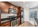 Well-equipped kitchen with stainless appliances, dark granite counters, and wood cabinets at 891 14Th St # 1506, Denver, CO 80202