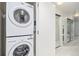 This laundry room features a stacked washer and dryer unit and mirrored sliding doors at 891 14Th St # 1506, Denver, CO 80202