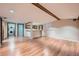 Finished basement area featuring a bar with white cabinets and wood-look floors, plus laundry access at 2446 S Vaughn Way # A, Aurora, CO 80014