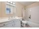 Bright bathroom with a single sink vanity, mirror and combination tub and shower at 2446 S Vaughn Way # A, Aurora, CO 80014