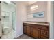 Bathroom with double sink vanity, granite countertops, and a glass shower at 2446 S Vaughn Way # A, Aurora, CO 80014