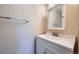 Clean half bath showcasing a white vanity with sink and mirror at 2446 S Vaughn Way # A, Aurora, CO 80014