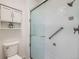 Tiled shower with a built-in seat and glass doors at 2446 S Vaughn Way # A, Aurora, CO 80014