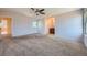 Large bedroom with ceiling fan, neutral carpet, and natural light from two windows at 2446 S Vaughn Way # A, Aurora, CO 80014