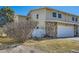 Charming exterior of townhome featuring a white garage door and stone accents at 2446 S Vaughn Way # A, Aurora, CO 80014