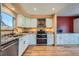 Bright kitchen features granite countertops, stainless steel appliances, and white cabinetry at 2446 S Vaughn Way # A, Aurora, CO 80014