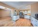 Modern open concept kitchen features granite countertops, stainless appliances, and hardwood floors at 2446 S Vaughn Way # A, Aurora, CO 80014