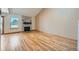 Open living room featuring hardwood floors, a stone fireplace, and natural light at 2446 S Vaughn Way # A, Aurora, CO 80014