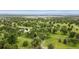 Breathtaking aerial view of lush landscape with meandering paths, mature trees, and serene pond at 3806 S Dawson St, Aurora, CO 80014
