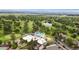 Aerial view of community clubhouse with pool, golf course, trees, and water feature at 3806 S Dawson St, Aurora, CO 80014
