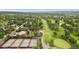 Aerial view of community tennis courts, golf course, water feature and tree-lined neighborhood at 3806 S Dawson St, Aurora, CO 80014