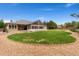 Wide backyard view, featuring a gravel border, lawn, patio, sunroom, and exterior of the house at 3806 S Dawson St, Aurora, CO 80014