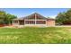 Backyard featuring grass, gravel, a sunroom, and the exterior of the house at 3806 S Dawson St, Aurora, CO 80014