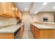 Basement bar area with wooden cabinets, countertop, stainless steel dishwasher, and open layout at 3806 S Dawson St, Aurora, CO 80014