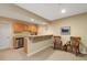 Basement bar area features wooden cabinets, countertop, stainless steel dishwasher and chairs at 3806 S Dawson St, Aurora, CO 80014