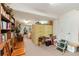 Basement featuring carpet flooring, wood chairs, book shelves, and storage items at 3806 S Dawson St, Aurora, CO 80014