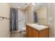 Neutral bathroom featuring a shower with blue striped curtain and vanity with tile countertops at 3806 S Dawson St, Aurora, CO 80014