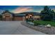 Stunning home at dusk with manicured landscaping and inviting exterior lighting at 3806 S Dawson St, Aurora, CO 80014