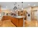 Spacious kitchen featuring a large island with a gas cooktop and bar stool seating, plus hardwood floors at 3806 S Dawson St, Aurora, CO 80014