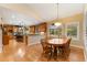 Open-concept kitchen and dining area with hardwood floors and lots of natural light at 3806 S Dawson St, Aurora, CO 80014