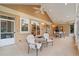 Covered patio with tiled flooring, ceiling fan, lounge chairs, and sliding glass door access at 3806 S Dawson St, Aurora, CO 80014
