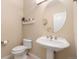 Stylish powder room with a pedestal sink, elegant mirror, and modern fixtures at 3806 S Dawson St, Aurora, CO 80014