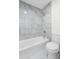 Modern bathroom with tiled shower and bathtub combination, tiled floors, and updated fixtures at 1519 S Sable Blvd # C, Aurora, CO 80012