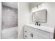 Well-lit bathroom with sleek vanity, marble countertop, and tiled shower-tub combo at 1519 S Sable Blvd # C, Aurora, CO 80012
