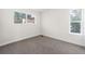 Bright bedroom with neutral carpet, white walls, and two windows providing ample natural light at 1519 S Sable Blvd # C, Aurora, CO 80012