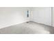 An airy bedroom featuring neutral carpet, a window, and a sliding door closet at 1519 S Sable Blvd # C, Aurora, CO 80012