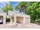 Exterior shot of home showing covered parking space and an attached one-car garage surrounded by mature trees at 1519 S Sable Blvd # C, Aurora, CO 80012