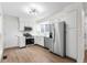 Bright kitchen featuring white cabinets, stainless steel appliances, granite countertops and hardwood floors at 1519 S Sable Blvd # C, Aurora, CO 80012