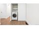 Convenient laundry area with a modern washing machine and storage shelves, located in a hallway at 1519 S Sable Blvd # C, Aurora, CO 80012