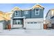 Two-story house with gray and white siding, a white door, and a two-car garage at 3372 N Buchanan Way, Aurora, CO 80019