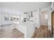 Modern kitchen with white cabinets, quartz countertops, and stainless steel appliances at 3372 N Buchanan Way, Aurora, CO 80019