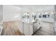 Open concept kitchen island with white cabinets and stainless steel appliances at 3372 N Buchanan Way, Aurora, CO 80019