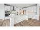 Modern kitchen with white cabinets, stainless steel appliances, and a large island at 3372 N Buchanan Way, Aurora, CO 80019