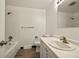 Bright bathroom featuring a tub with tiled walls, and a modern sink and vanity at 6432 Zephyr St, Arvada, CO 80004