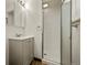 Bathroom features a white shower, vanity, and a neutral color palette at 6432 Zephyr St, Arvada, CO 80004
